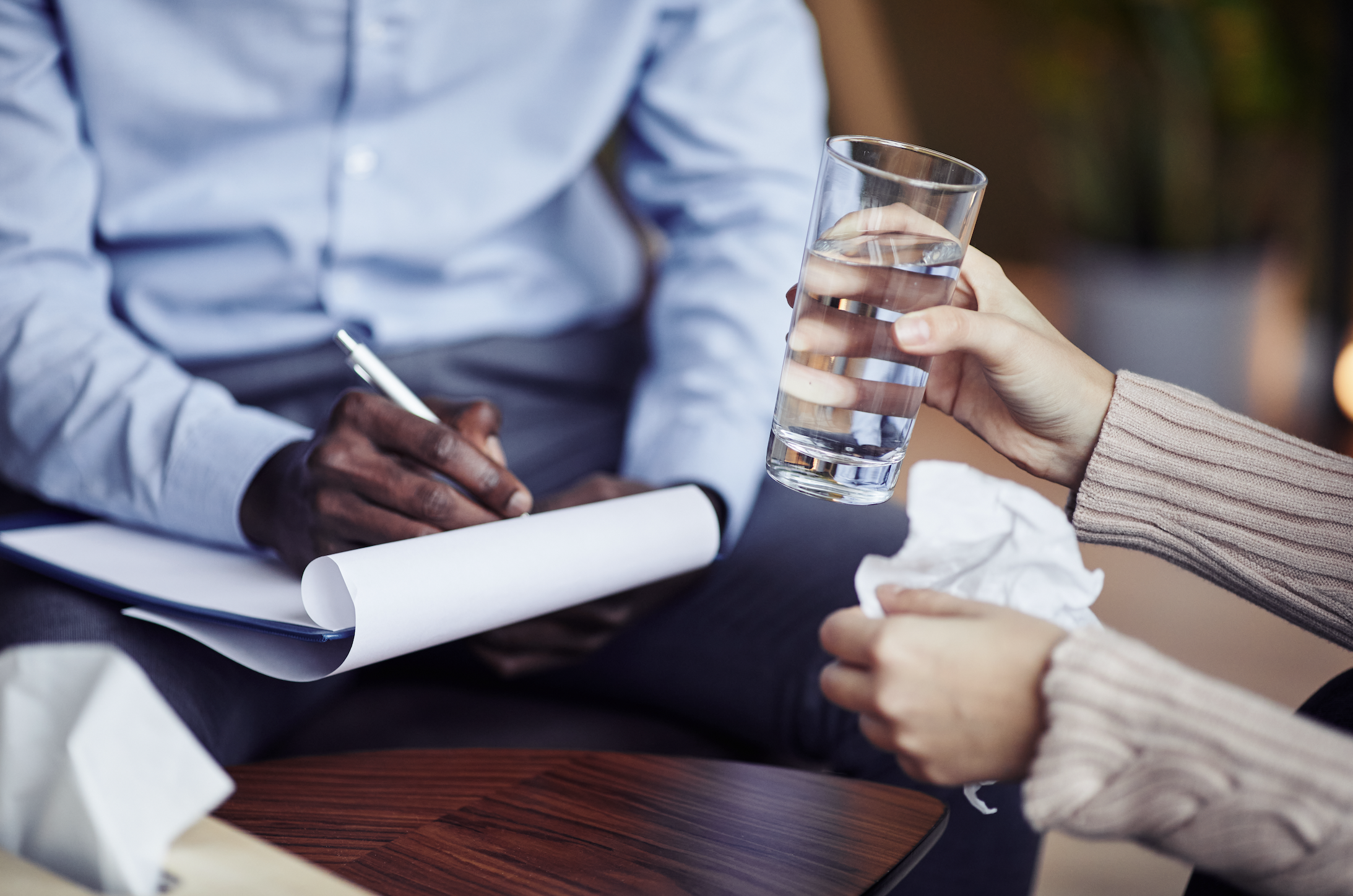 A man and woman holding a glass of water.